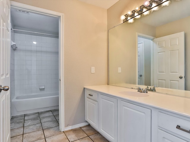 bathroom featuring vanity and tiled shower / bath