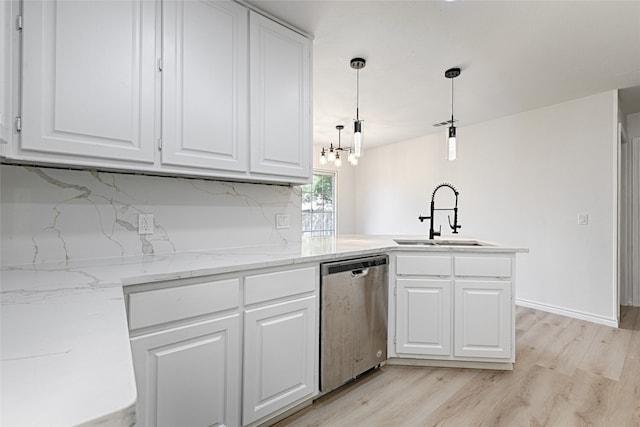 kitchen featuring white cabinetry, pendant lighting, sink, and stainless steel dishwasher