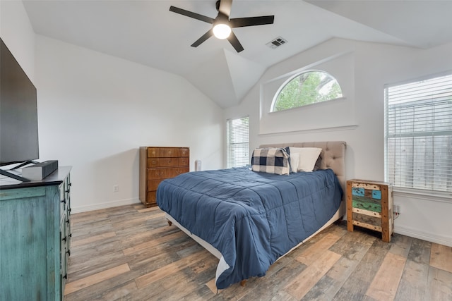 bedroom with hardwood / wood-style flooring, vaulted ceiling, and ceiling fan