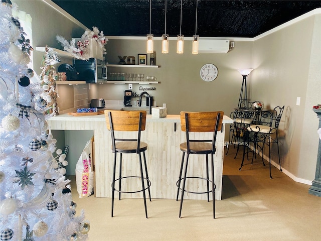 kitchen featuring a wall mounted air conditioner, a kitchen bar, open shelves, carpet flooring, and baseboards