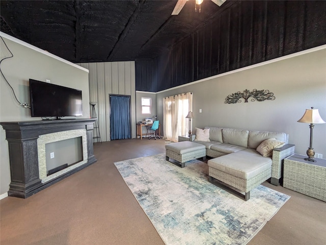 living room with ceiling fan, carpet floors, and a high ceiling