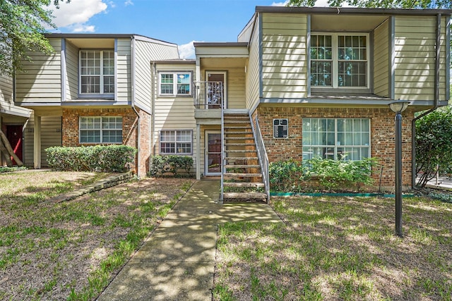 multi unit property featuring brick siding and stairway