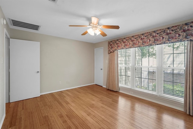 spare room with light wood-type flooring and ceiling fan