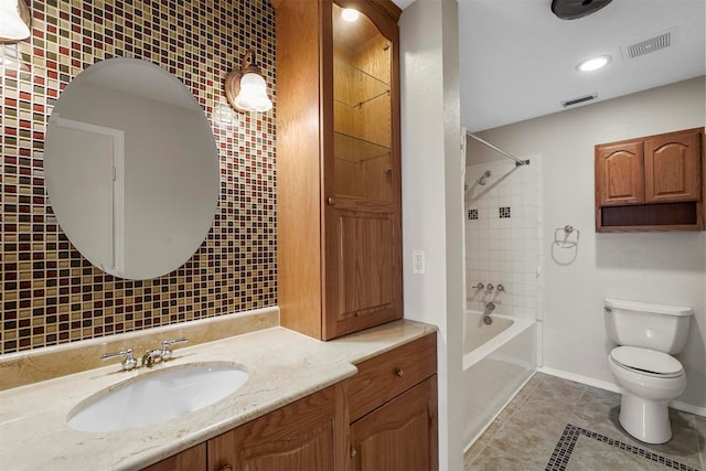 full bathroom with tile patterned flooring, toilet, vanity, and tiled shower / bath