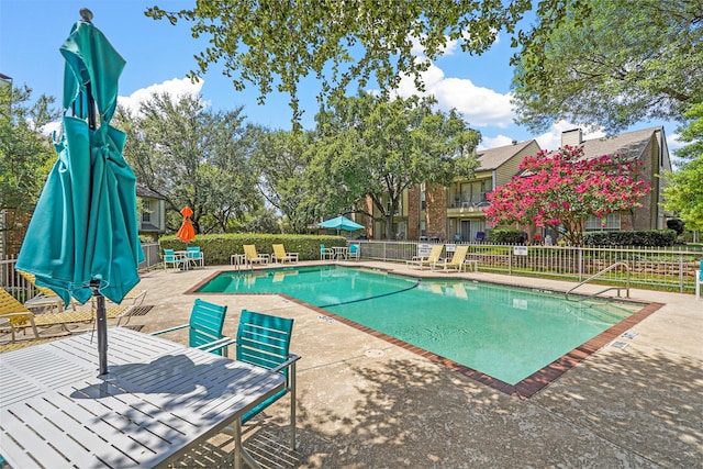 view of swimming pool with a patio area