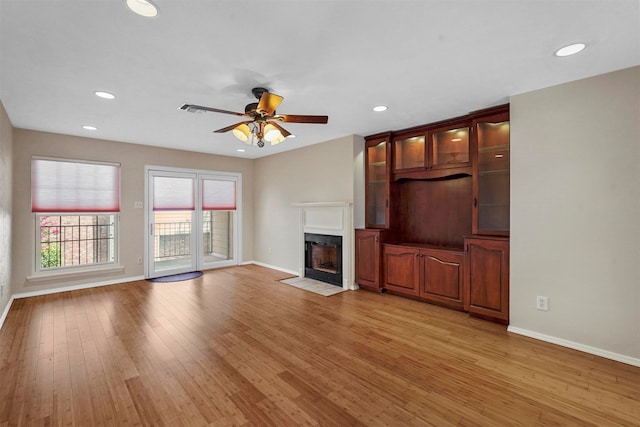 unfurnished living room featuring light hardwood / wood-style floors and ceiling fan