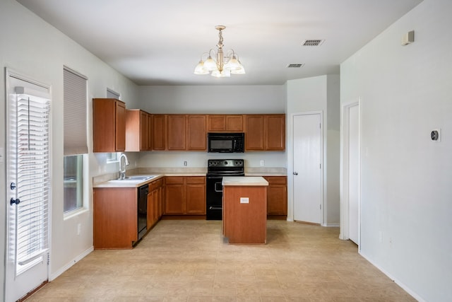 kitchen featuring sink, an inviting chandelier, black appliances, a kitchen island, and decorative light fixtures