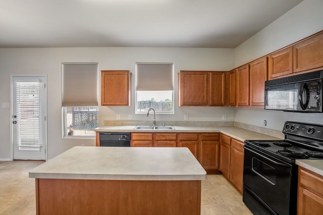 kitchen featuring sink, light tile patterned flooring, black appliances, and a kitchen island