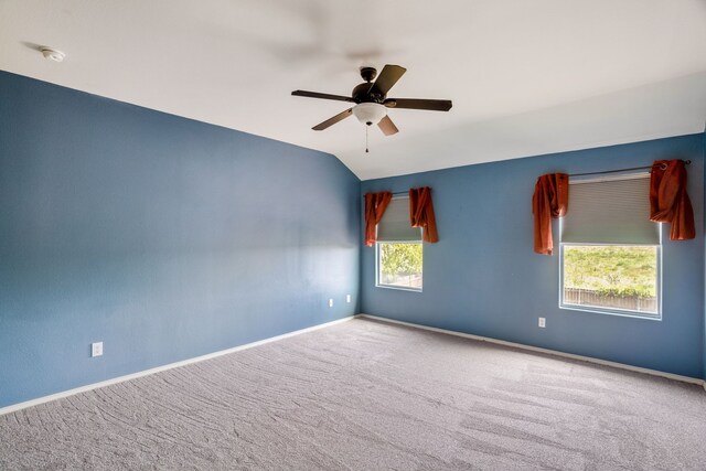 unfurnished room featuring vaulted ceiling, carpet floors, and ceiling fan