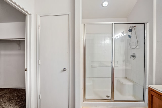 bathroom with walk in shower and vanity