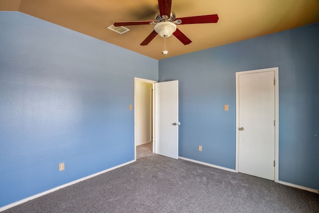 unfurnished bedroom featuring carpet floors, ceiling fan, and vaulted ceiling