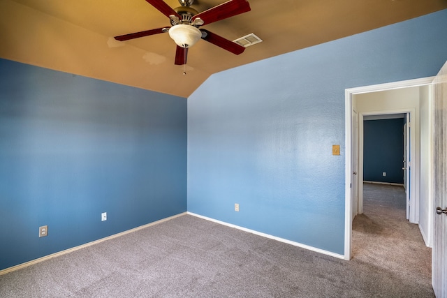 carpeted empty room with ceiling fan and vaulted ceiling