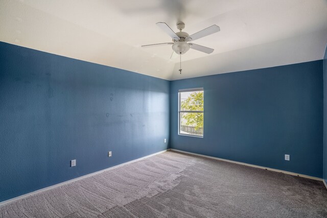 spare room featuring carpet floors and ceiling fan