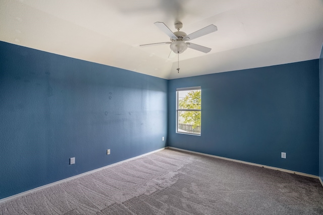 unfurnished room featuring lofted ceiling, carpet flooring, and ceiling fan