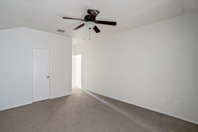 spare room featuring carpet, lofted ceiling, and ceiling fan