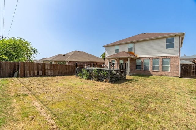 rear view of property with a yard