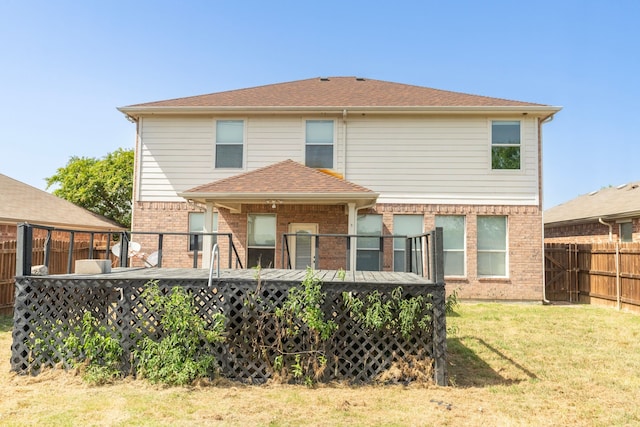 rear view of property featuring a yard