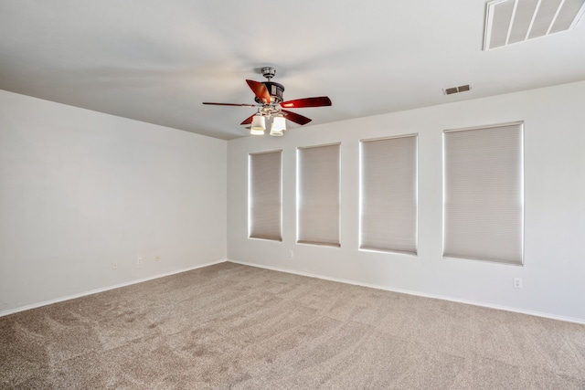 spare room with light carpet and ceiling fan