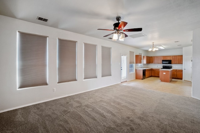 unfurnished living room with light colored carpet and ceiling fan