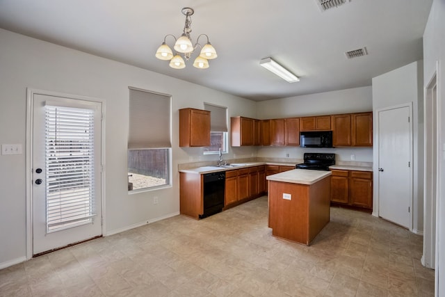 kitchen with black appliances, sink, light tile patterned floors, a center island, and a chandelier