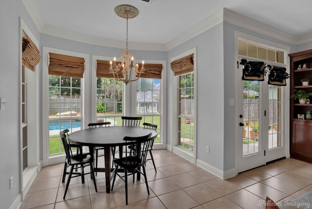 tiled dining area with crown molding, plenty of natural light, and a notable chandelier