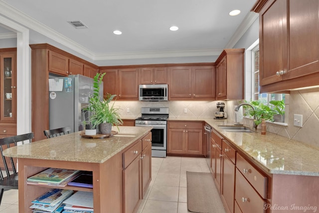 kitchen with a breakfast bar, a kitchen island, stainless steel appliances, and sink