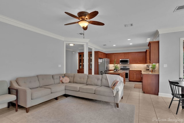 living room with crown molding, light tile patterned floors, and ceiling fan