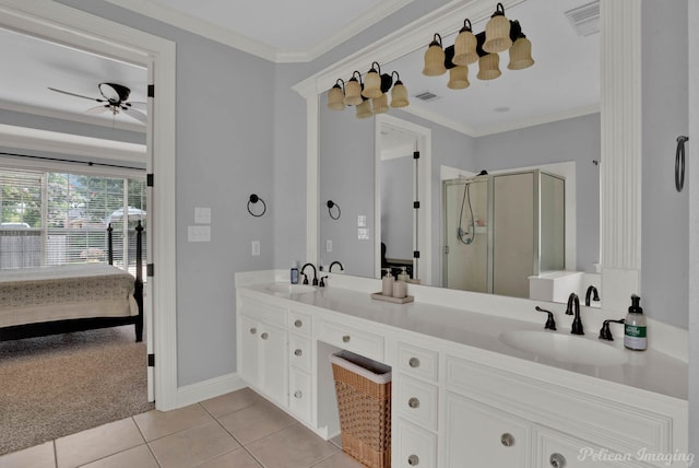 bathroom featuring tile patterned floors, ornamental molding, vanity, ceiling fan, and a shower with shower door