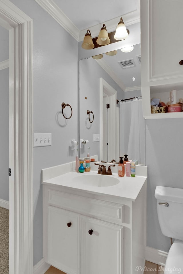 bathroom with vanity, curtained shower, toilet, and ornamental molding