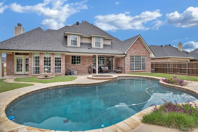 view of swimming pool featuring an in ground hot tub and a patio