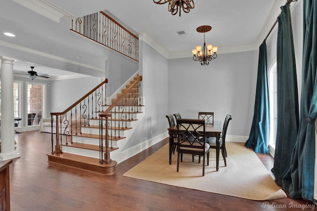 dining room featuring hardwood / wood-style floors, ceiling fan with notable chandelier, decorative columns, and ornamental molding