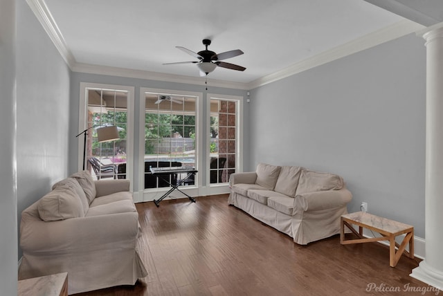 living room with ceiling fan, dark hardwood / wood-style flooring, crown molding, and decorative columns