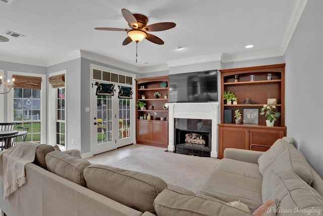 tiled living room with crown molding and ceiling fan with notable chandelier