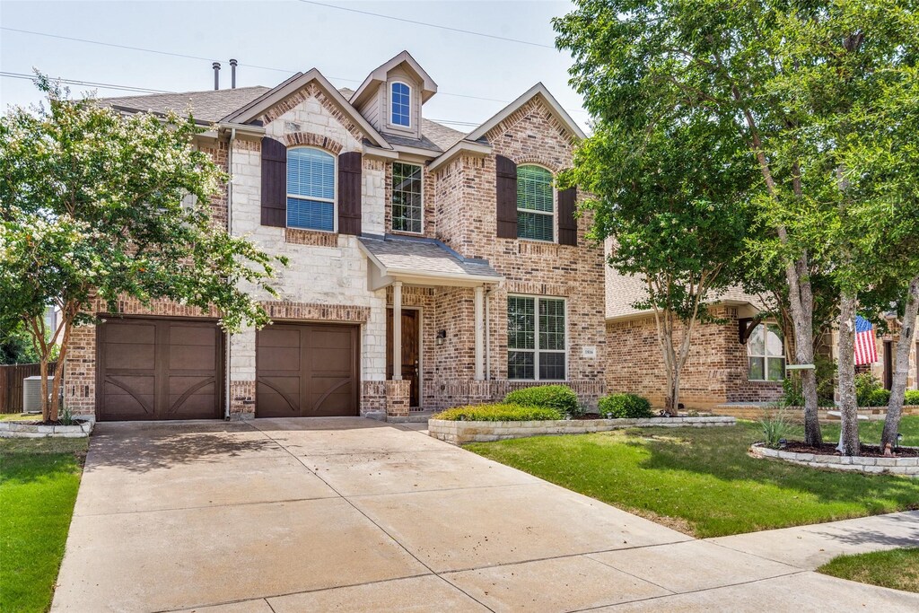 view of front of home with a garage and a front lawn