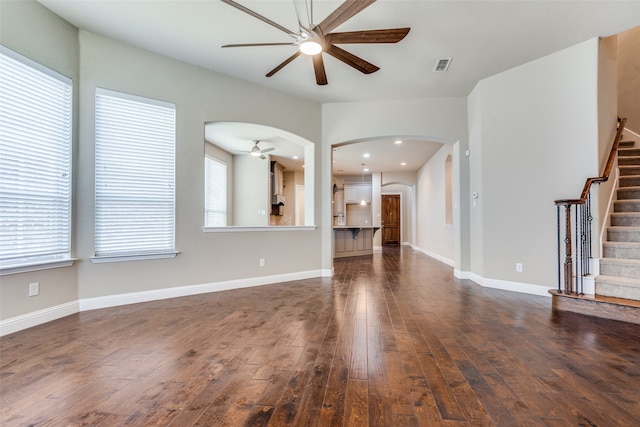 unfurnished living room featuring wood-type flooring and ceiling fan