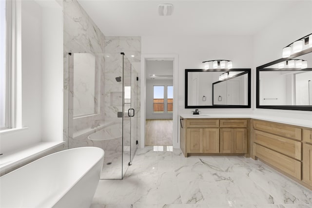 bathroom with shower with separate bathtub and vanity