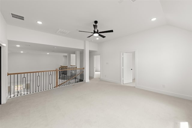 unfurnished living room featuring ceiling fan, light carpet, and vaulted ceiling