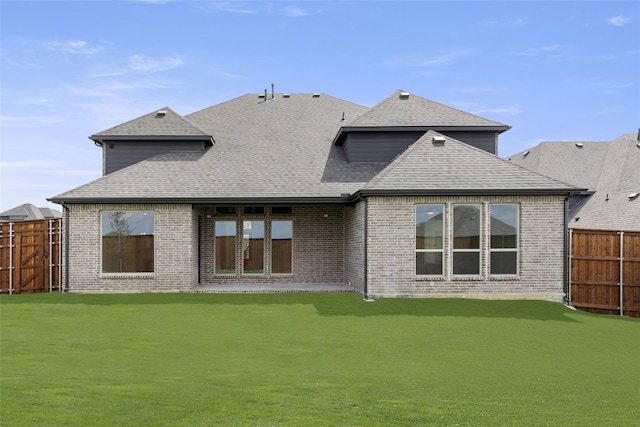 back of house featuring a lawn