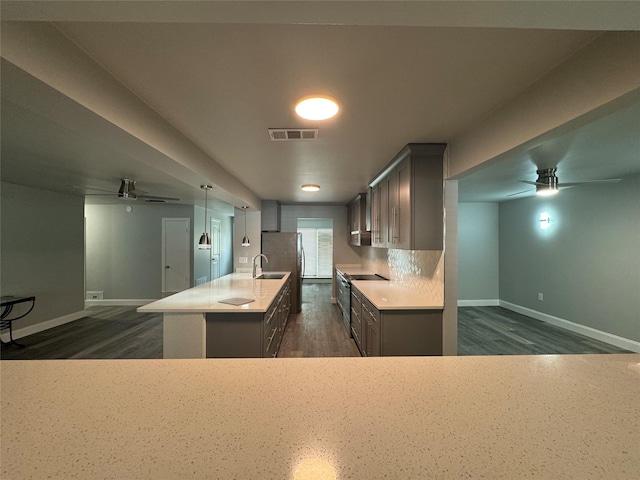 kitchen with visible vents, baseboards, ceiling fan, and dark wood-style floors