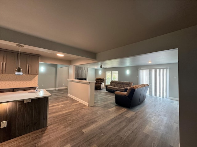 living room with baseboards, a ceiling fan, dark wood-type flooring, and recessed lighting