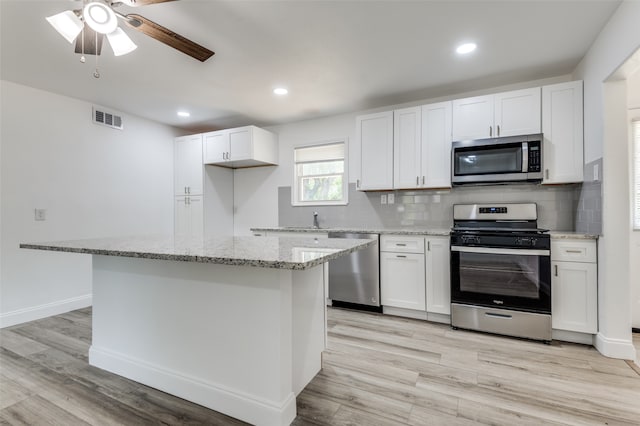 kitchen featuring ceiling fan, white cabinets, and appliances with stainless steel finishes