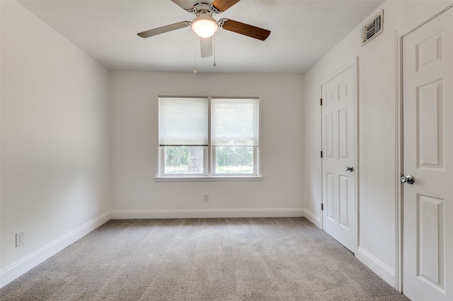 unfurnished bedroom featuring ceiling fan and light colored carpet