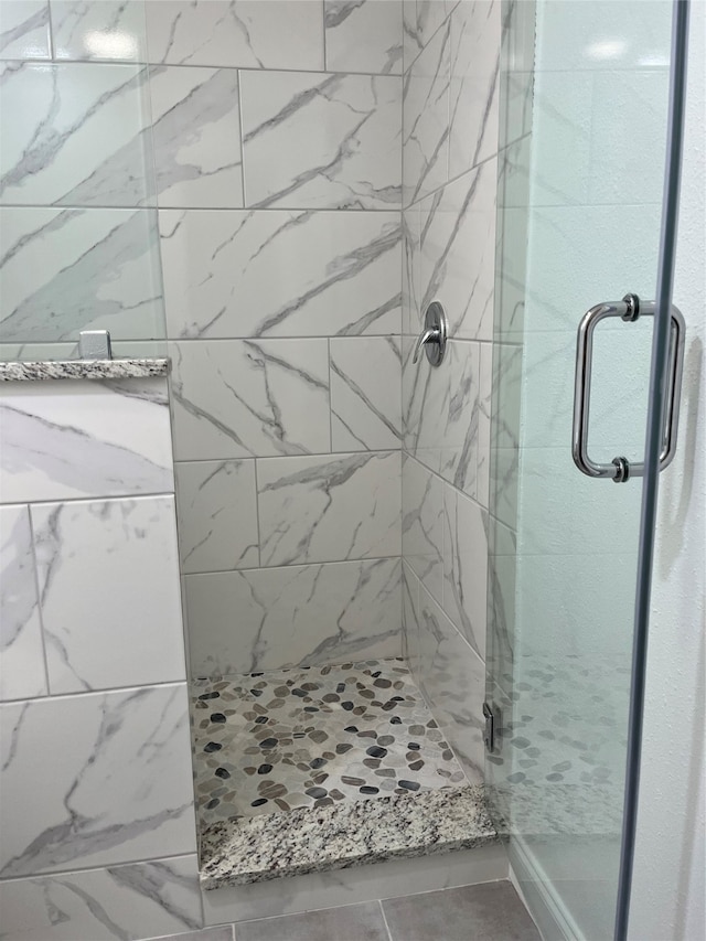 bathroom with a shower with shower door