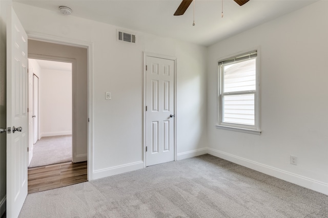 unfurnished bedroom with carpet floors, a closet, and ceiling fan