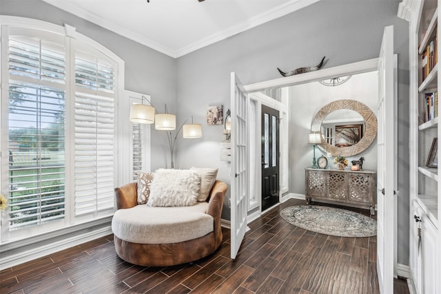 sitting room featuring dark wood-type flooring and crown molding