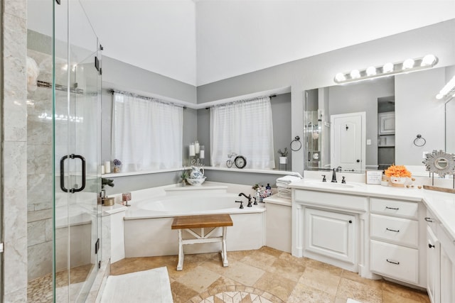 bathroom with vanity, plus walk in shower, a high ceiling, and tile patterned floors