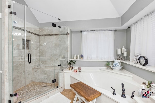 bathroom featuring shower with separate bathtub, tile patterned floors, and vaulted ceiling