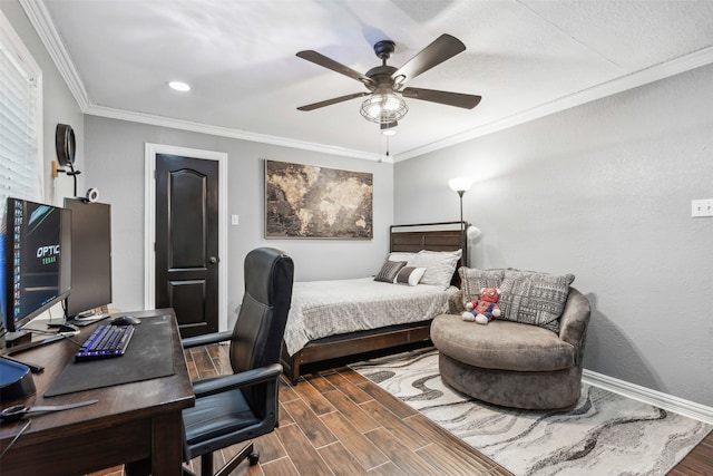 bedroom featuring dark hardwood / wood-style flooring, ceiling fan, and crown molding