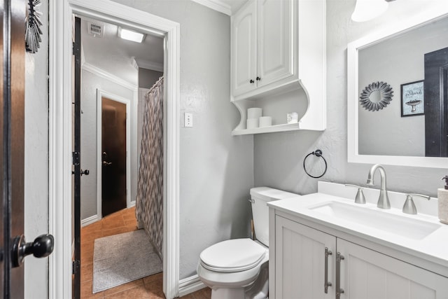 bathroom with vanity, toilet, tile patterned floors, and crown molding