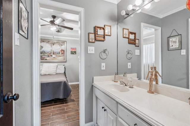 bathroom featuring ceiling fan, vanity, and ornamental molding